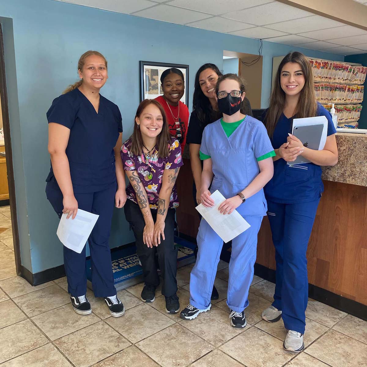 a group of women in scrubs and face masks